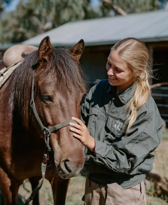 A mother is sat in between her husband and son in a smart office looking relaxed and happy for a consultation