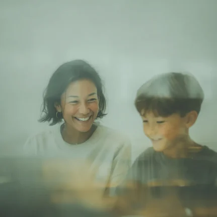 Candid photograph of a happy teacher with their student one to one lesson